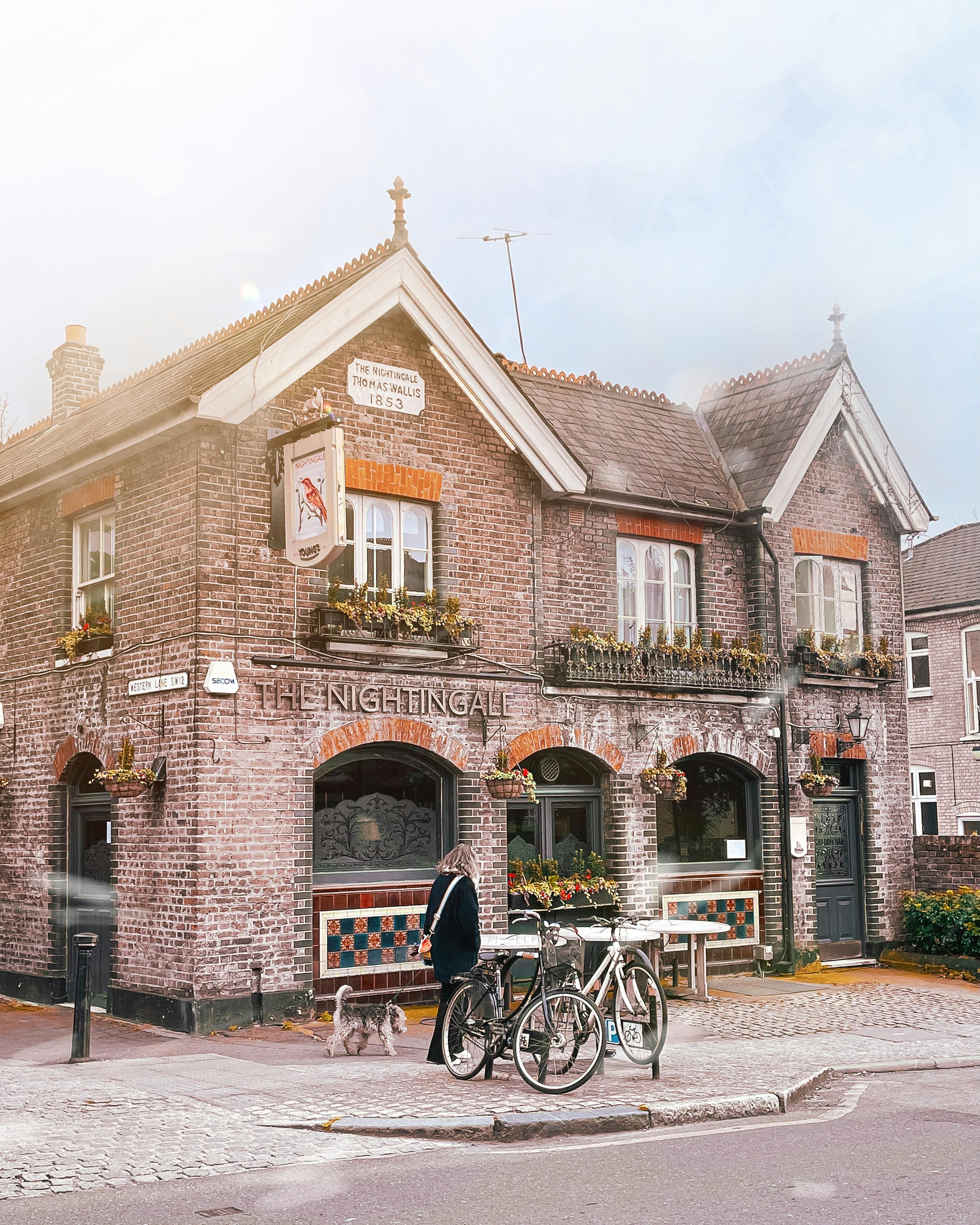 Free A quaint vintage pub with unique architecture on a quiet city street, captured in daylight. Stock Photo