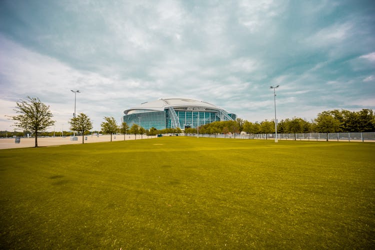 Green Stadium Near Modern Building