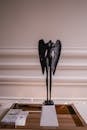 Black Headless Angel Figurine on White Pedestal