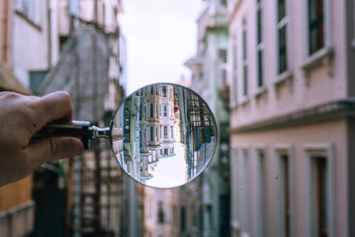 Free A Person Holding a Magnifying Glass Stock Photo