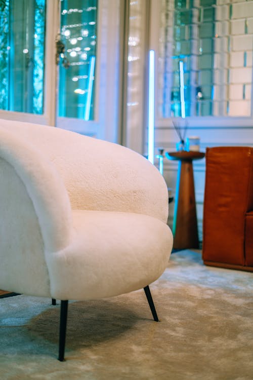 White Velvet Padded Chair on Gray Carpet