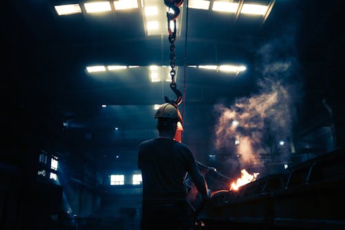 Free Man Working In An Industrial Factory  Stock Photo