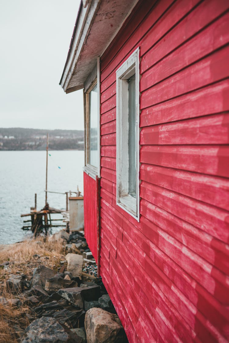 Old House With Pink Exterior Wall Beside A River