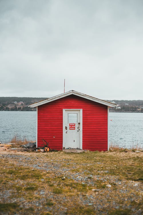 Old Building With Red Painted Wall Beside A River