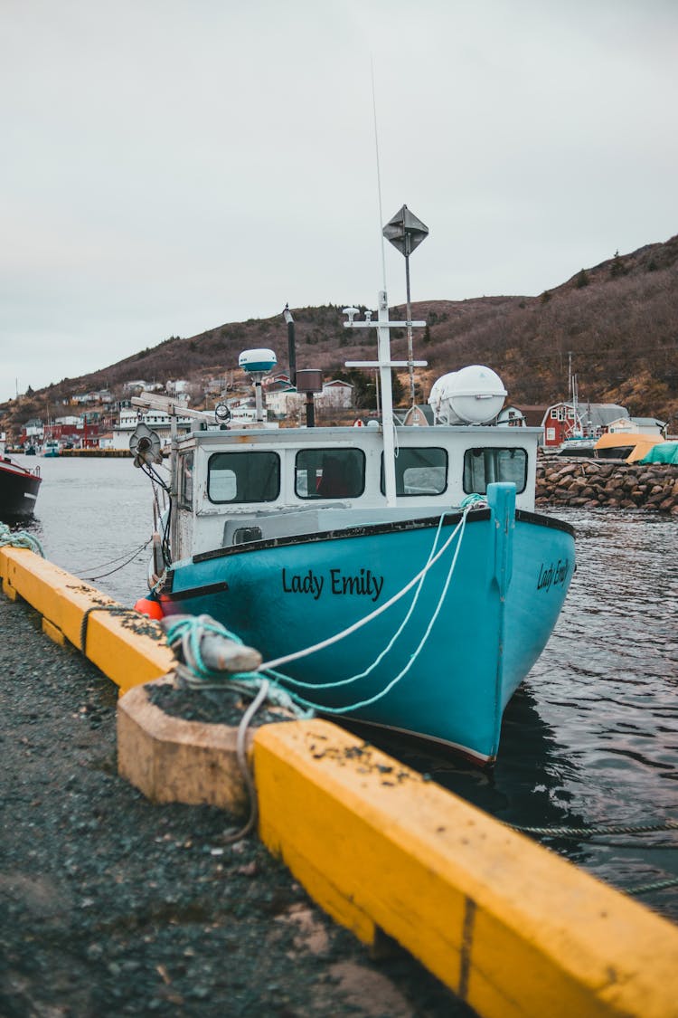 Blue And White Boat Docked With Ropes