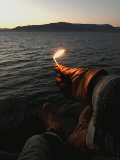 A Person Holding a Burning Match