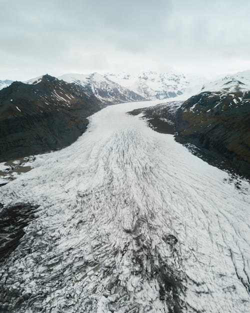 Aerial View Of Snow Covered Path And Mountains 