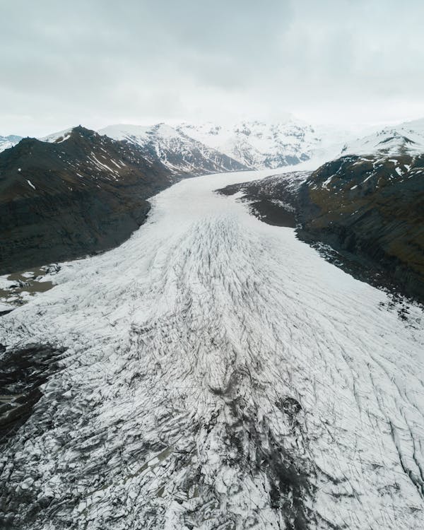 Aerial View Of Snow Covered Path And Mountains 