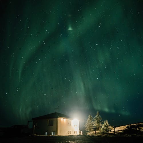 Northern Lights Above a House
