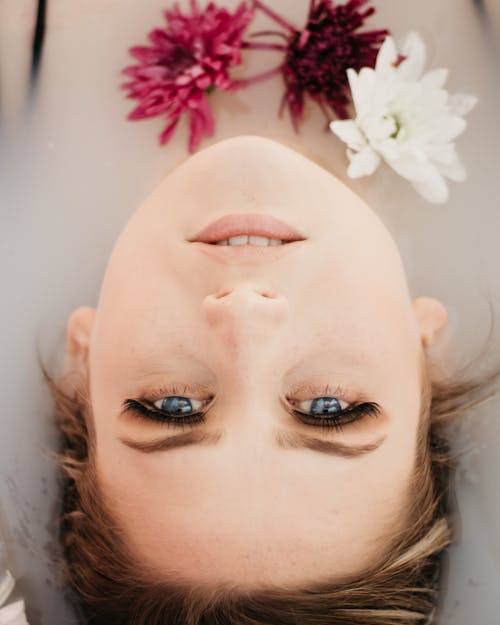 An Upside Down Shot of a Woman Lying Down on Water