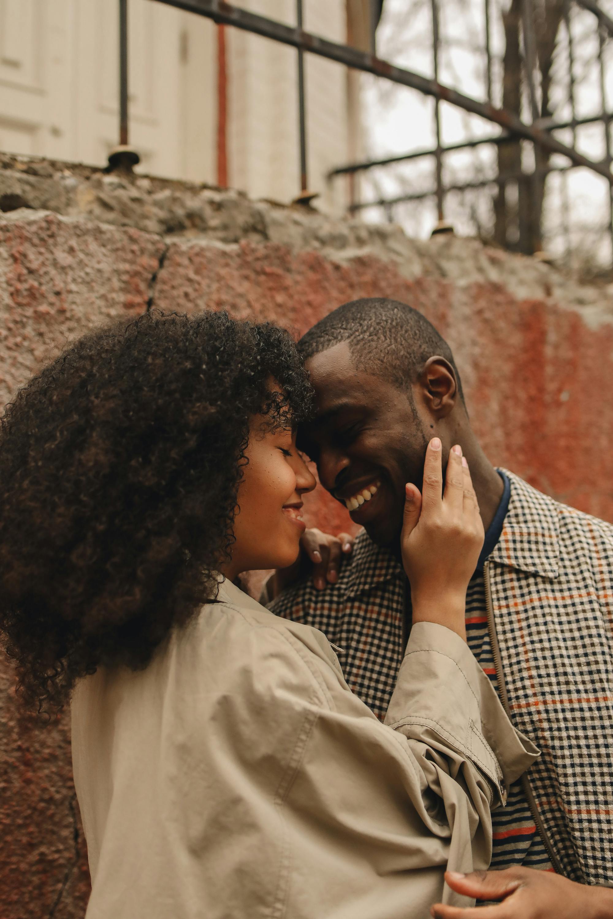 Portrait of a joyful couple sharing a tender moment outdoors, exuding love and warmth.