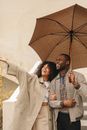 Woman Beside Man in Plaid Jacket Holding Umbrella