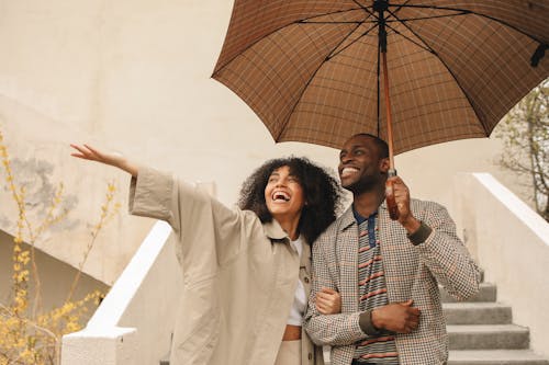 Happy Couple Holding Umbrella