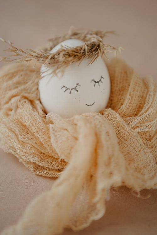 Free White Egg on Brown Knit Textile Stock Photo