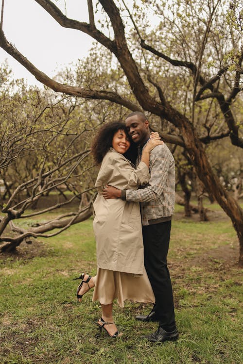 Free Photo of a Couple Hugging Near Trees Stock Photo
