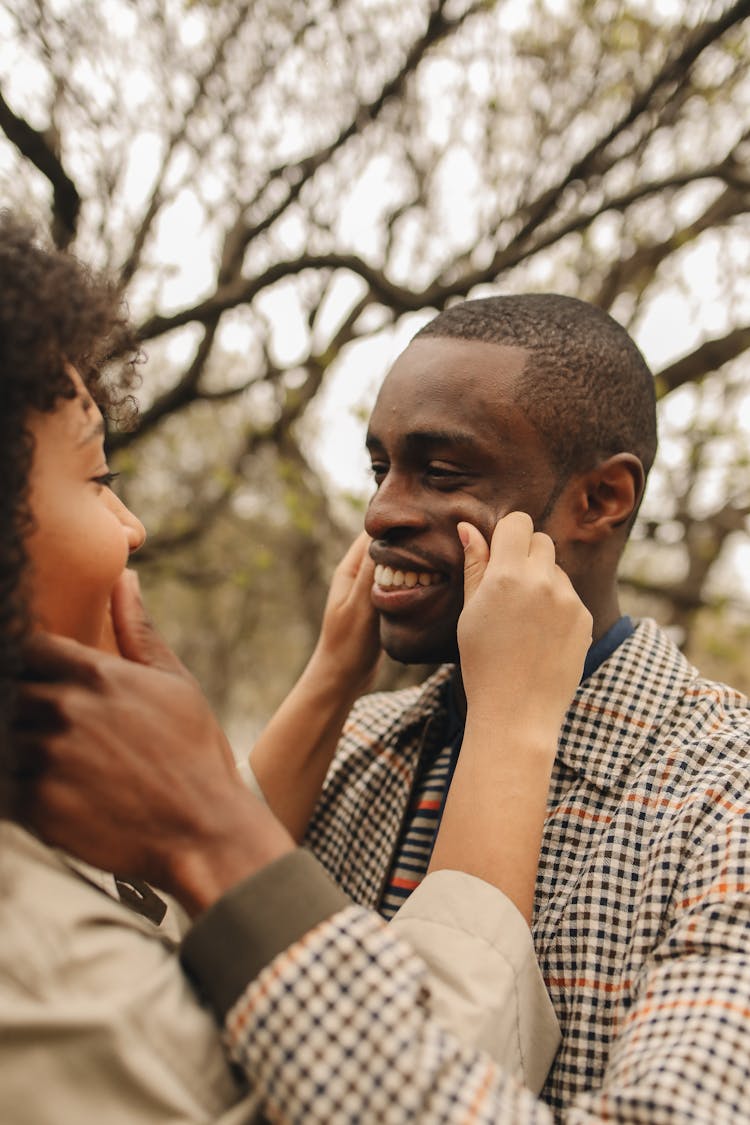 Man And Woman Pinching Each Other's Cheeks