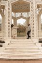 Man and Woman Walking on White Concrete Stairs