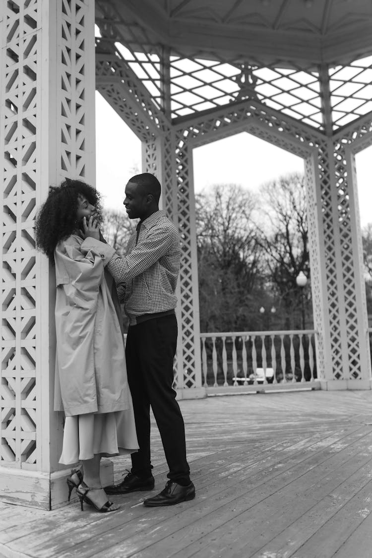 Man Holding The Face Of A Woman While In A Park