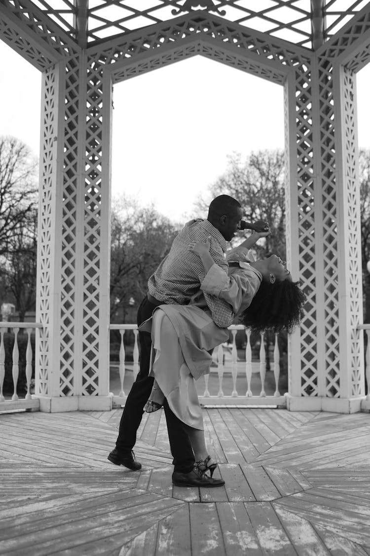 Couple Dancing On Wooden Floor