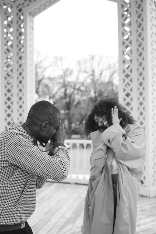 Grayscale Photography of Man Taking Photo of a Woman 