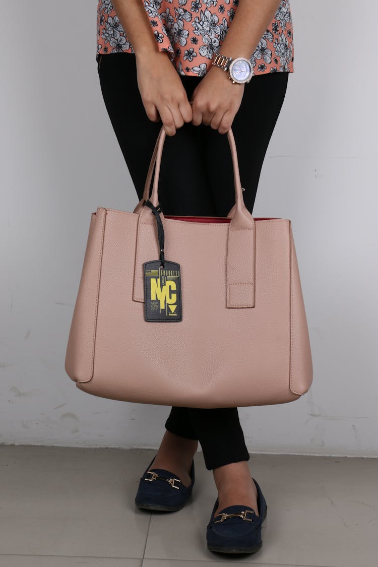 A Person Holding A Beige Tote Bag