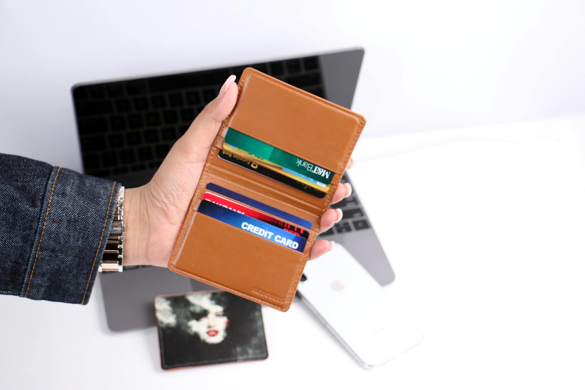 A Person Holding a Wallet with Cards