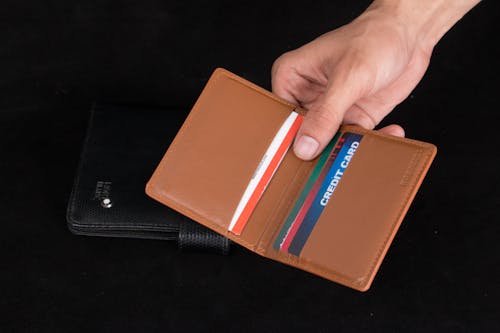 Free Hand Holding Brown Leather Card Holder Stock Photo