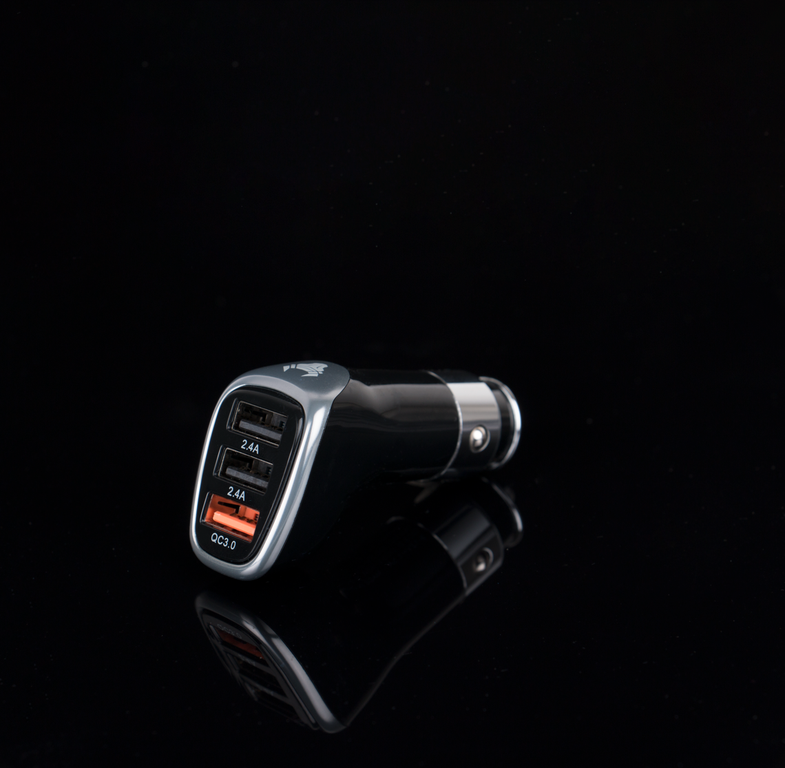Black and silver multi-port car charger photographed as a real automotive accessory