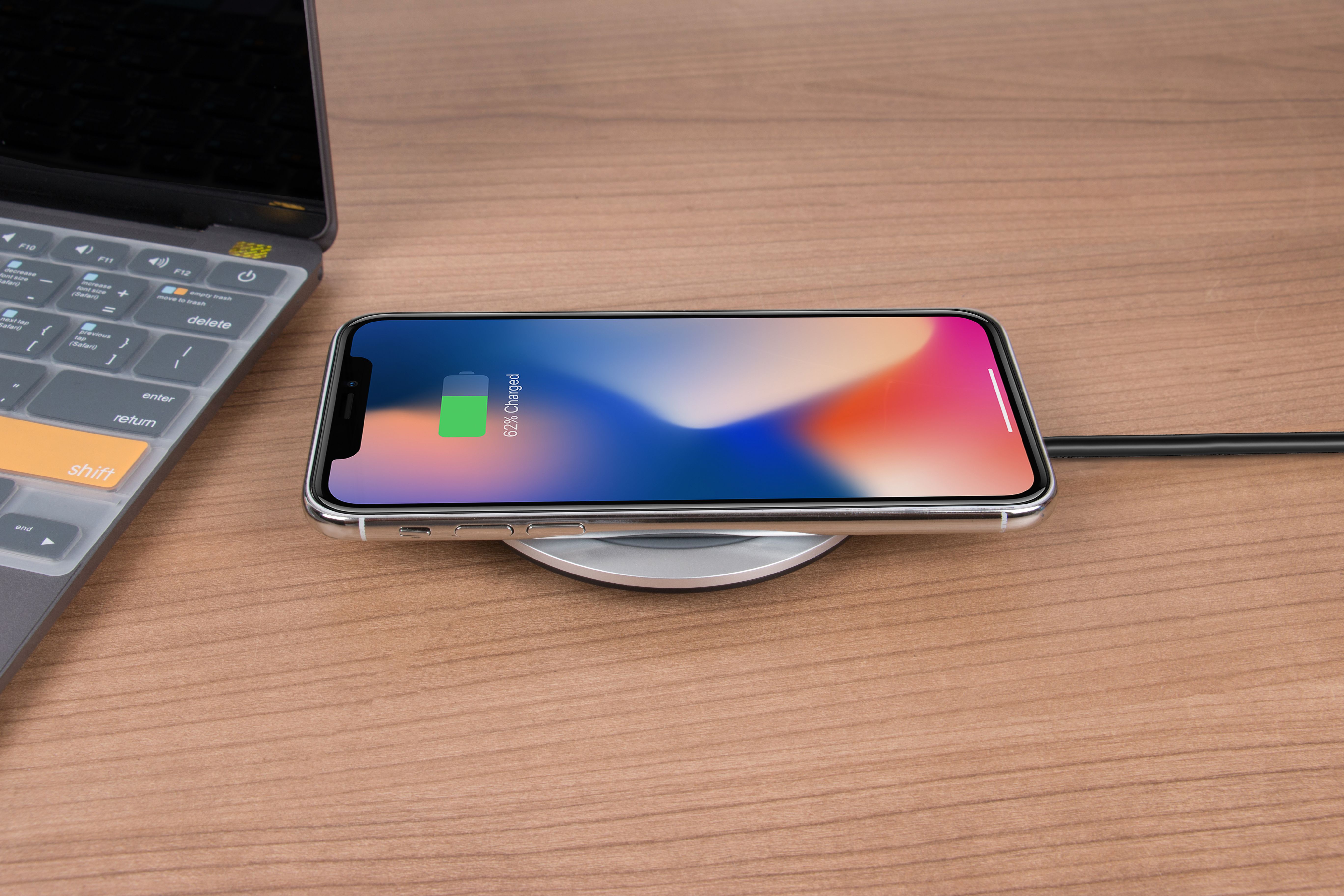 iPhone charging on a desk