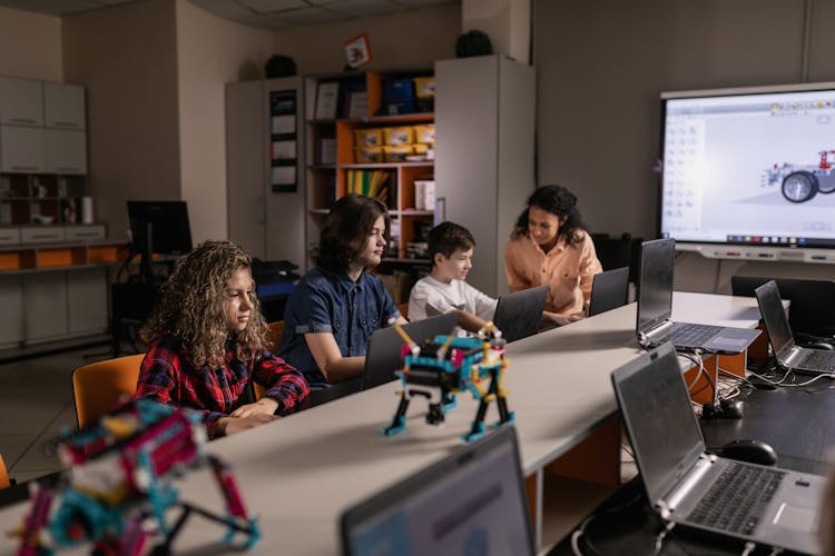 Students Using Laptop Inside The Classroom