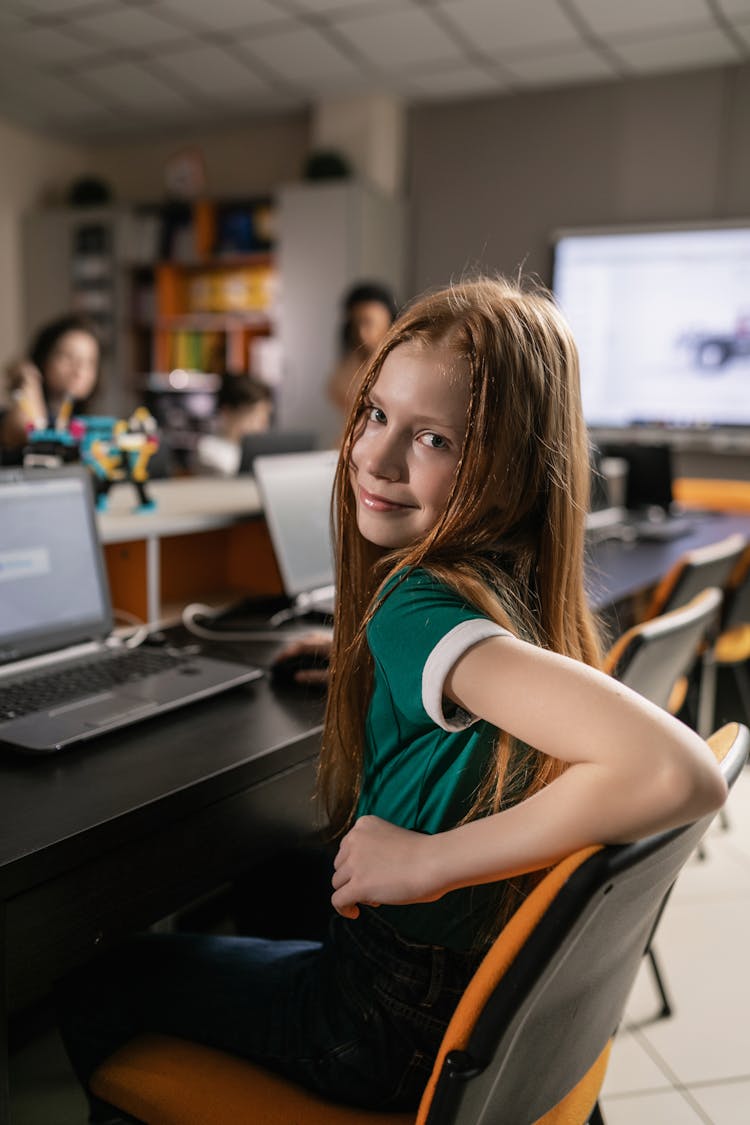 Girl In Green Shirt Sitting On Chair