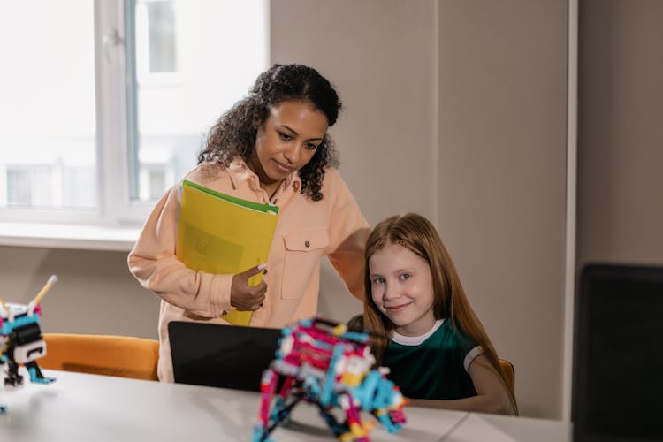 Girl And Her Teacher In A Classroom