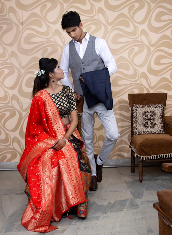 A couple sitting in a clean, organized living room, representing a harmonious home.
