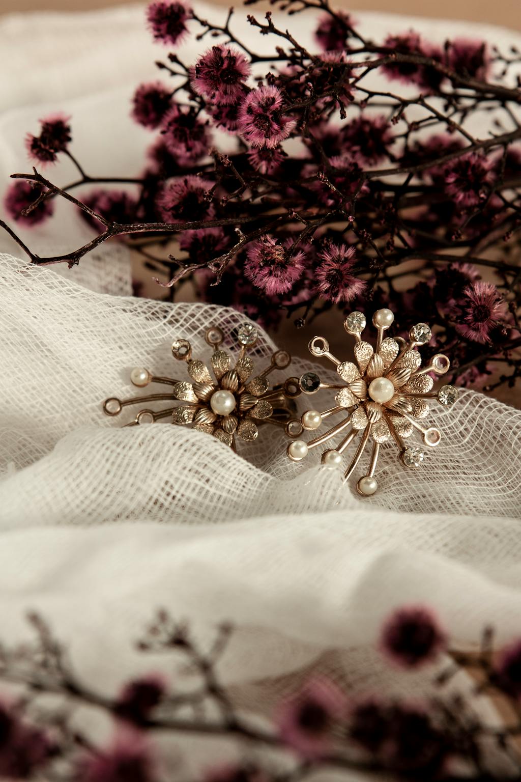 Victorian-style pearl jewelry on fabric with flowers