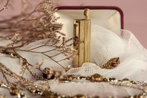 Free Close-up of luxurious gold jewelry and dry flowers with a soft, artistic ambiance. Stock Photo