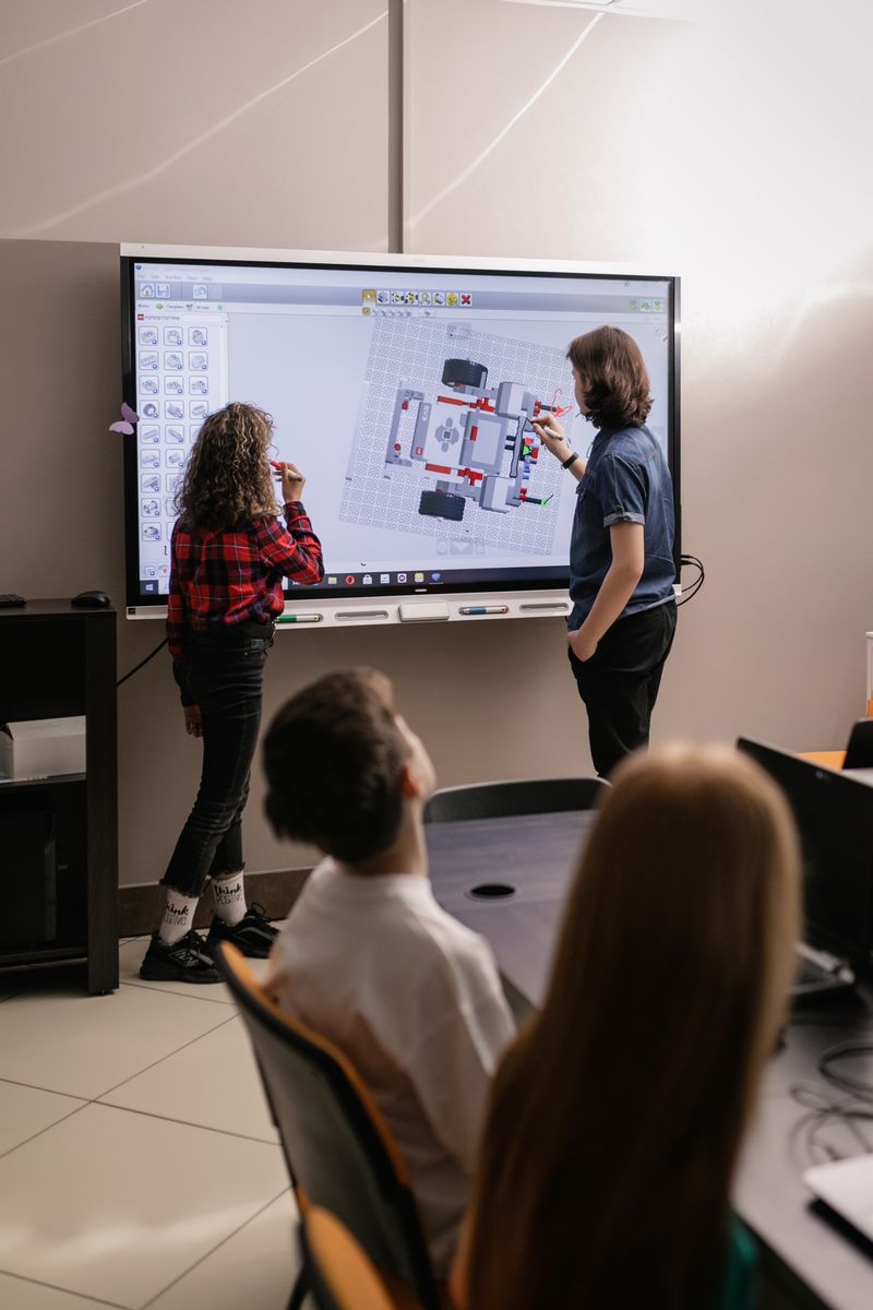 Students using an interactive board in a classroom