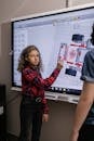 A Girl Standing by an Interactive Board
