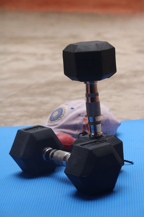 Weight training at a gym, photo by Manoj Poosam on Pexels
