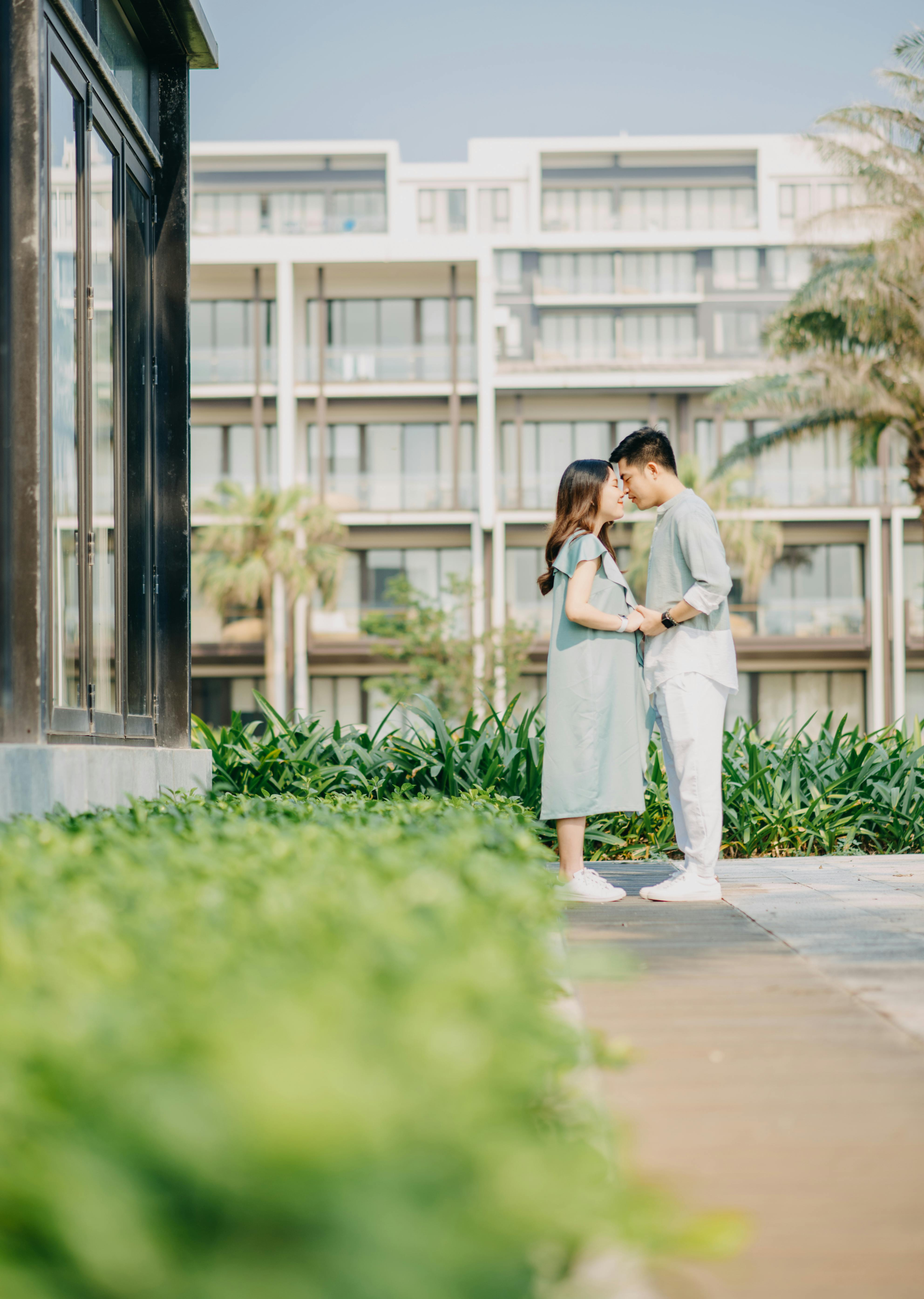 positive asian couple cuddling and holding hands