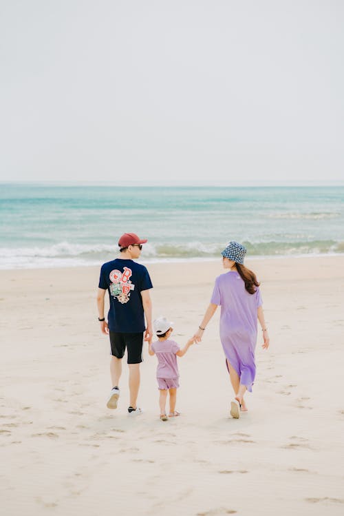 Loving mother and father holding hands with little cute offspring