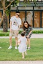 Asian stylish father and mother playing with little daughter
