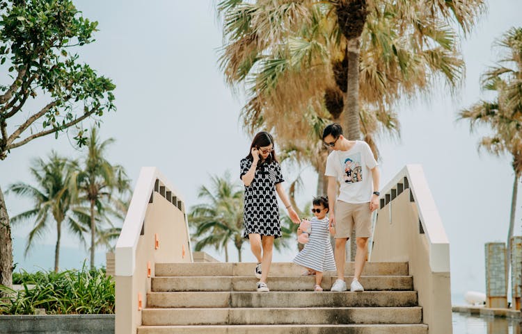 Young Family Descend From Bridge In Summer