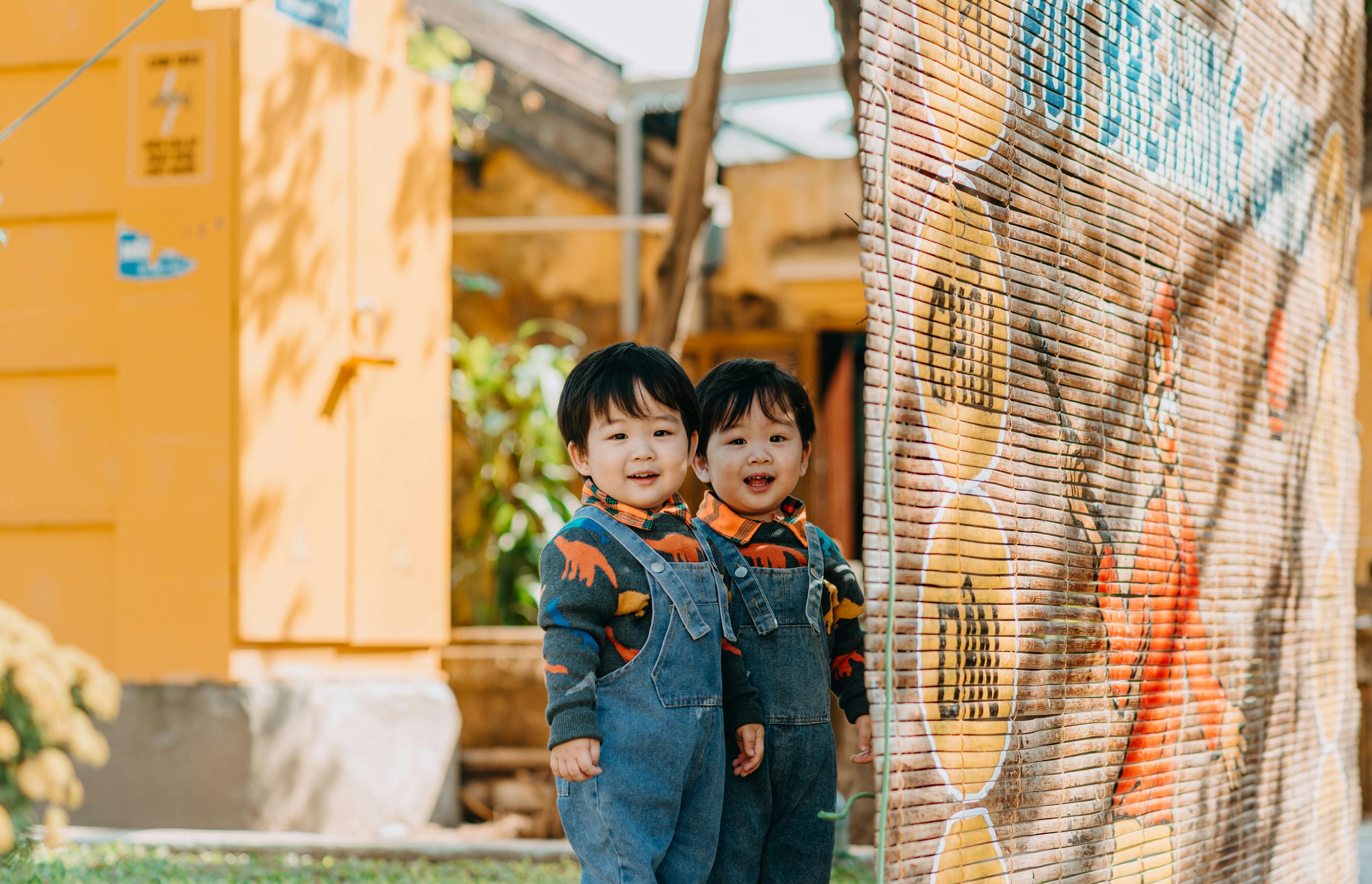 children wearing denim jumpers