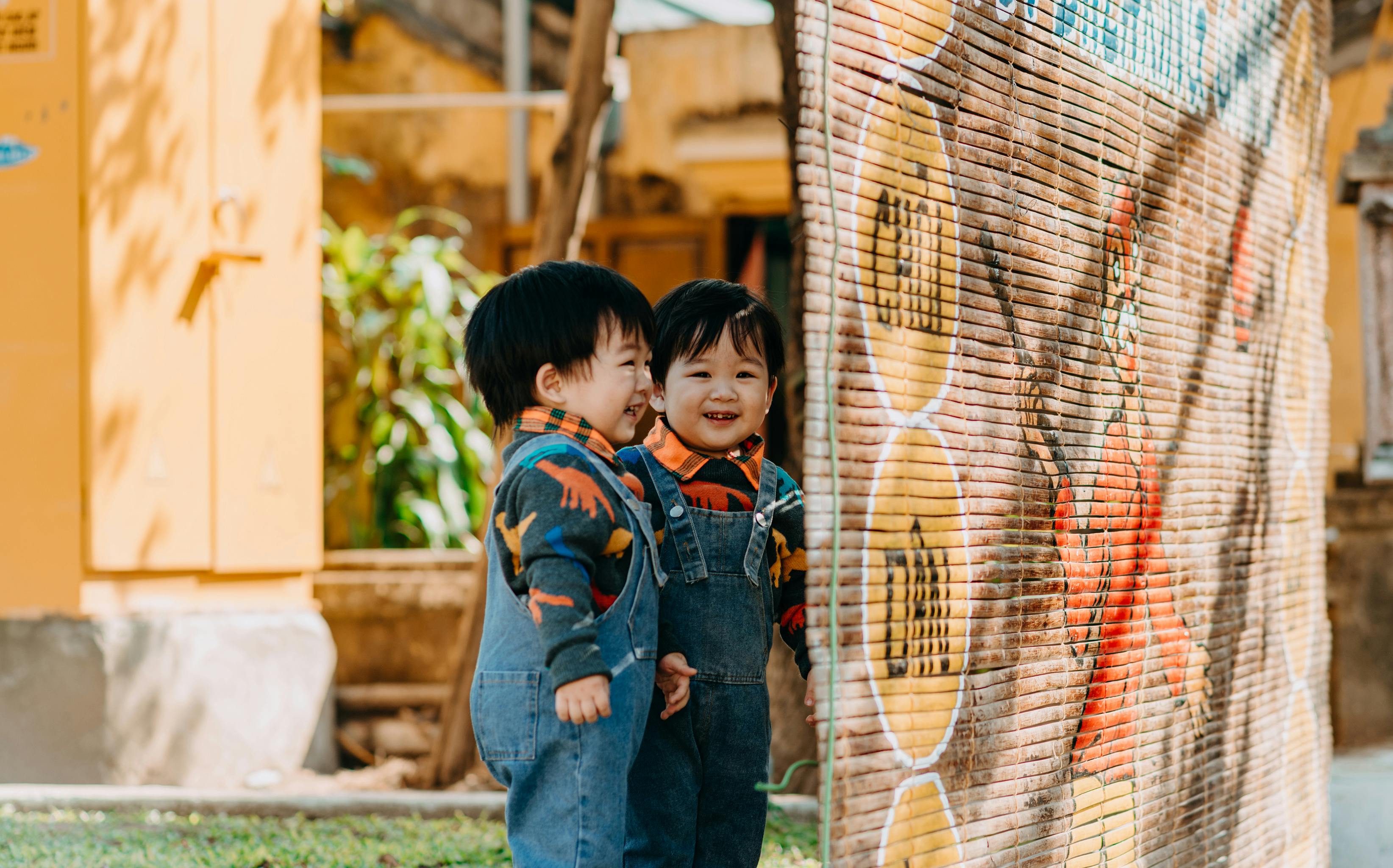 children wearing denim jumpers