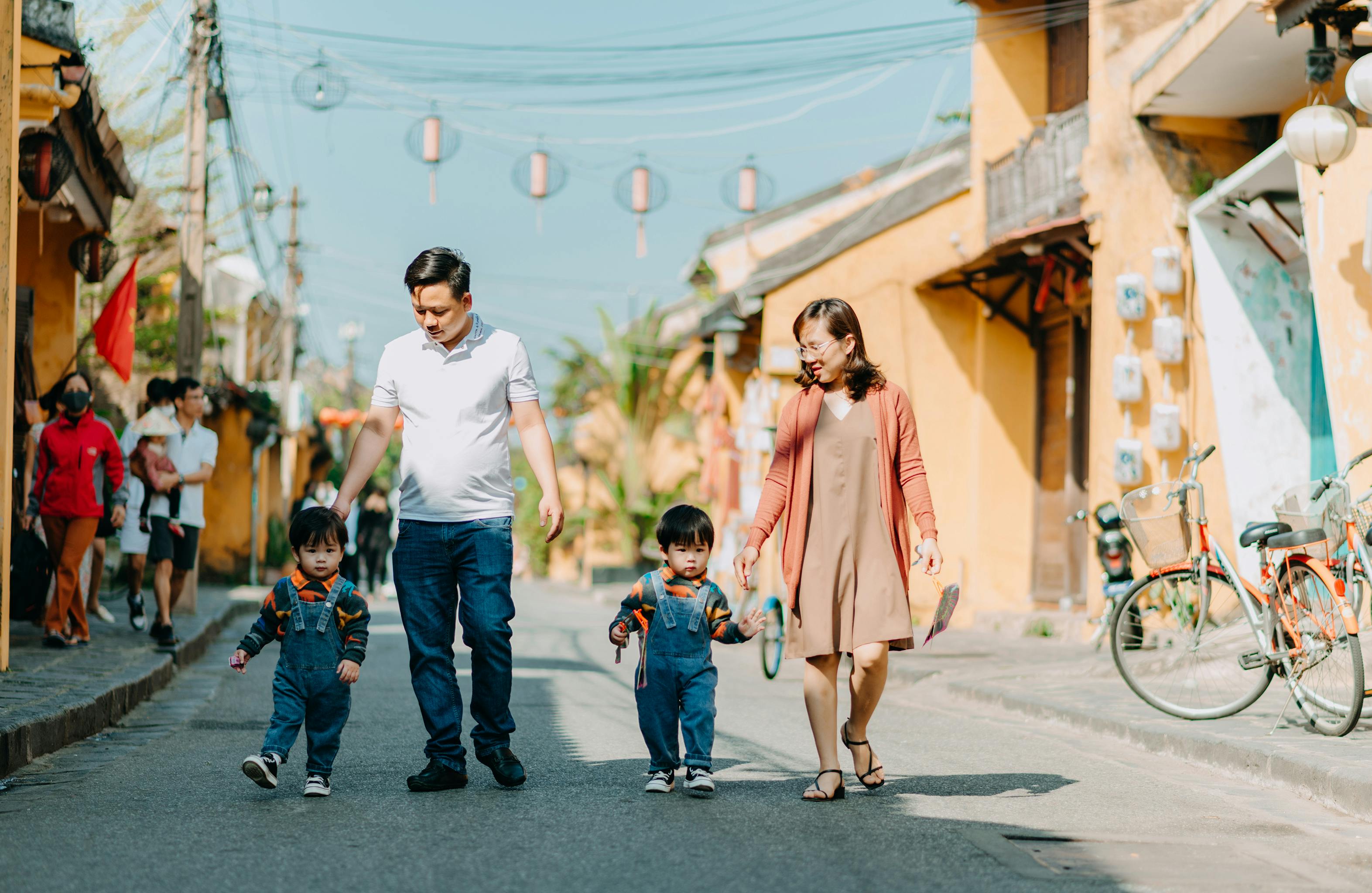 parents walking with their children wearing denim jumpers