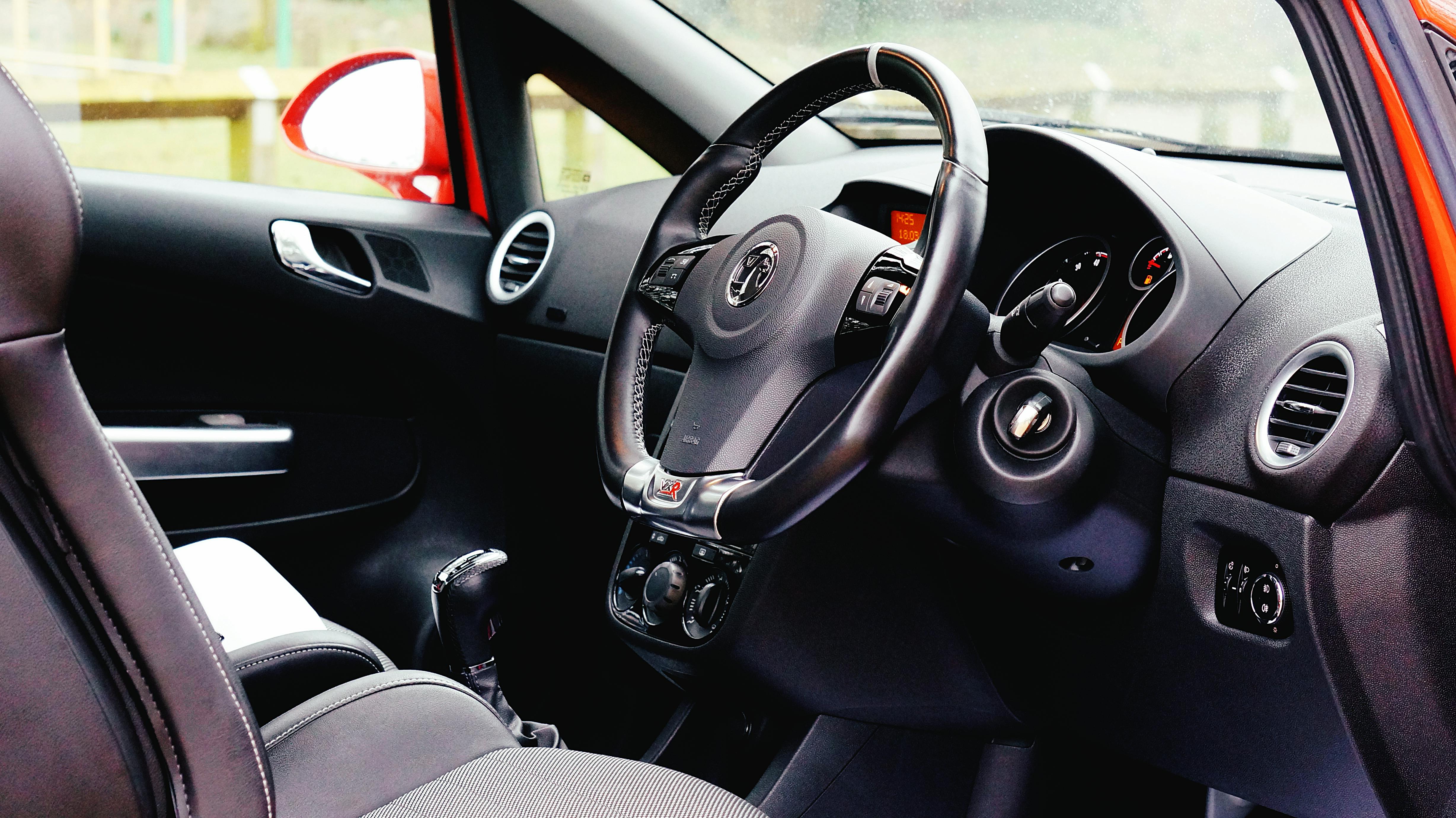 Close-up of a modern car interior featuring a steering wheel and dashboard.