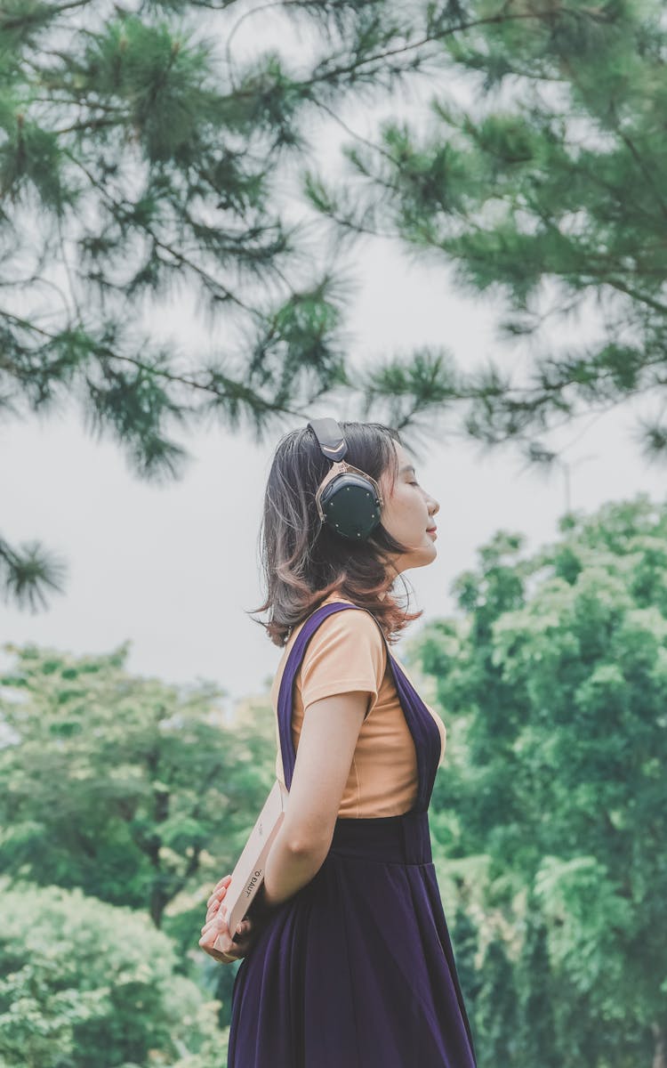 Young Girl In Purple Jumper Dress Wearing Headphone