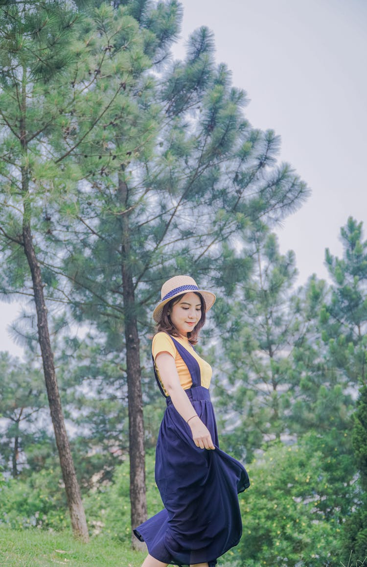 Woman In Navy Blue Skirt And Hat In The Park 