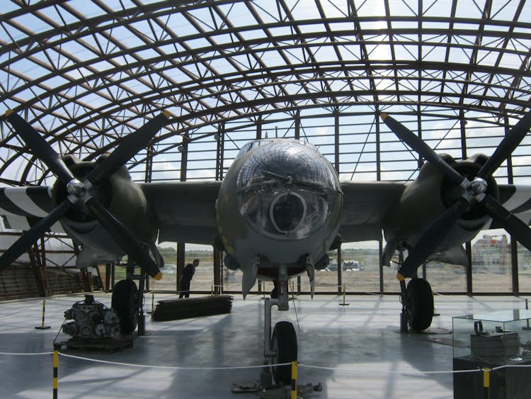 Gray Bomber Plane Parked In Gray Steel Structure