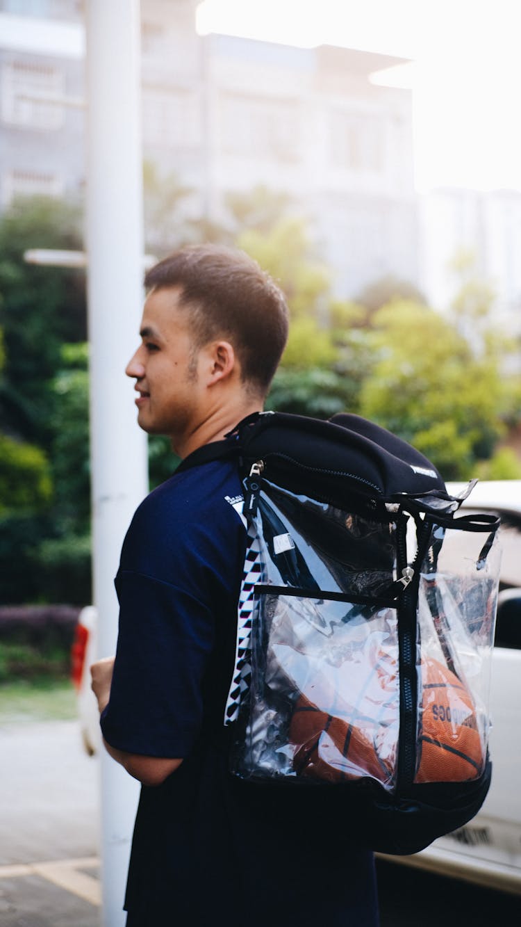 Man With Clear Plastic Back Pack With Basketball